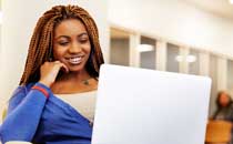 Student smiling and using laptop