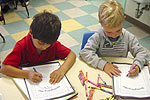Children writing in workbooks