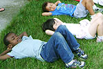 Children laying in grass