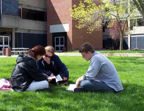 students reading in courtyard