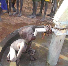 Photo of child drinking from pipe