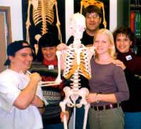 Students holding a skeleton model