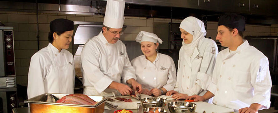 Students learning from a chef