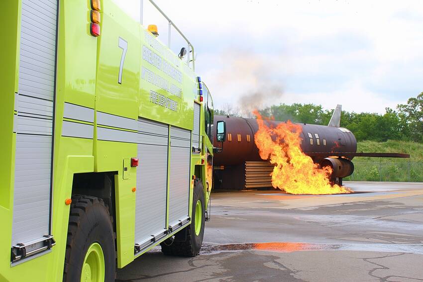Airport fire rescue vehicle on scene of burning aircraft