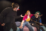 Student in all black with a clown masks pointing at student in red sweater