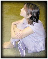 Girl in purple dress sitting on the ground