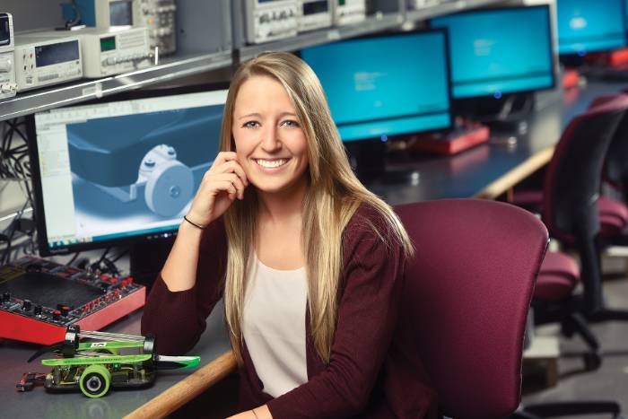 Maggie bates sitting in an engineering lab