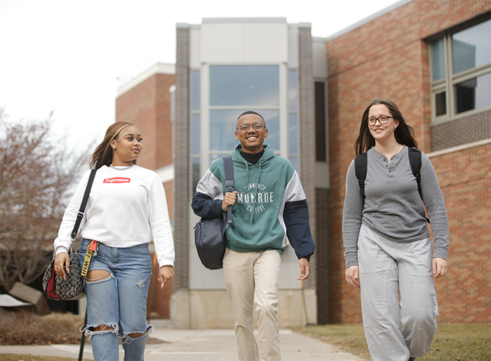 Three students walk outside on MCC's Brighton Campus
