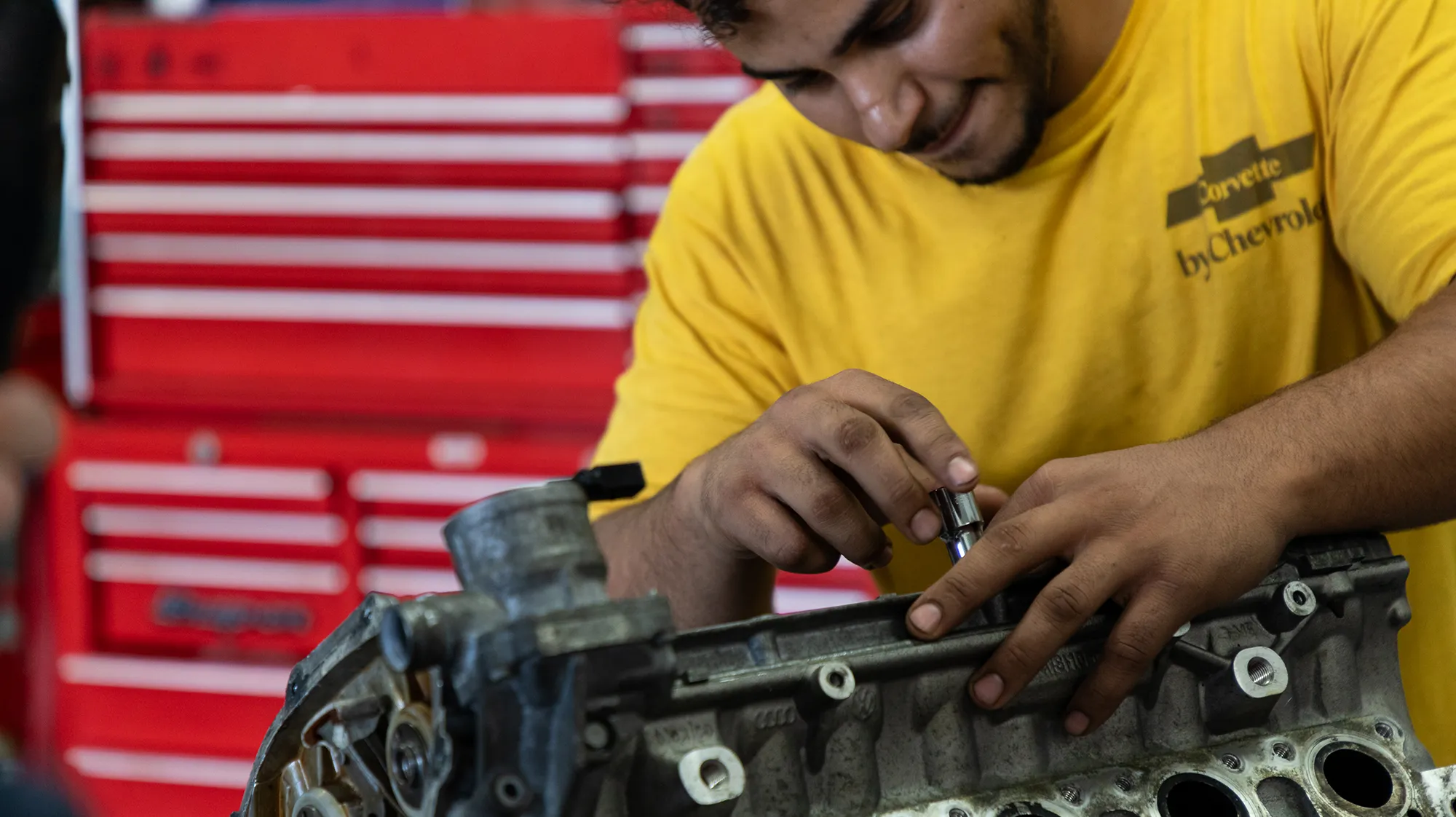 An automotive technology student works on a project