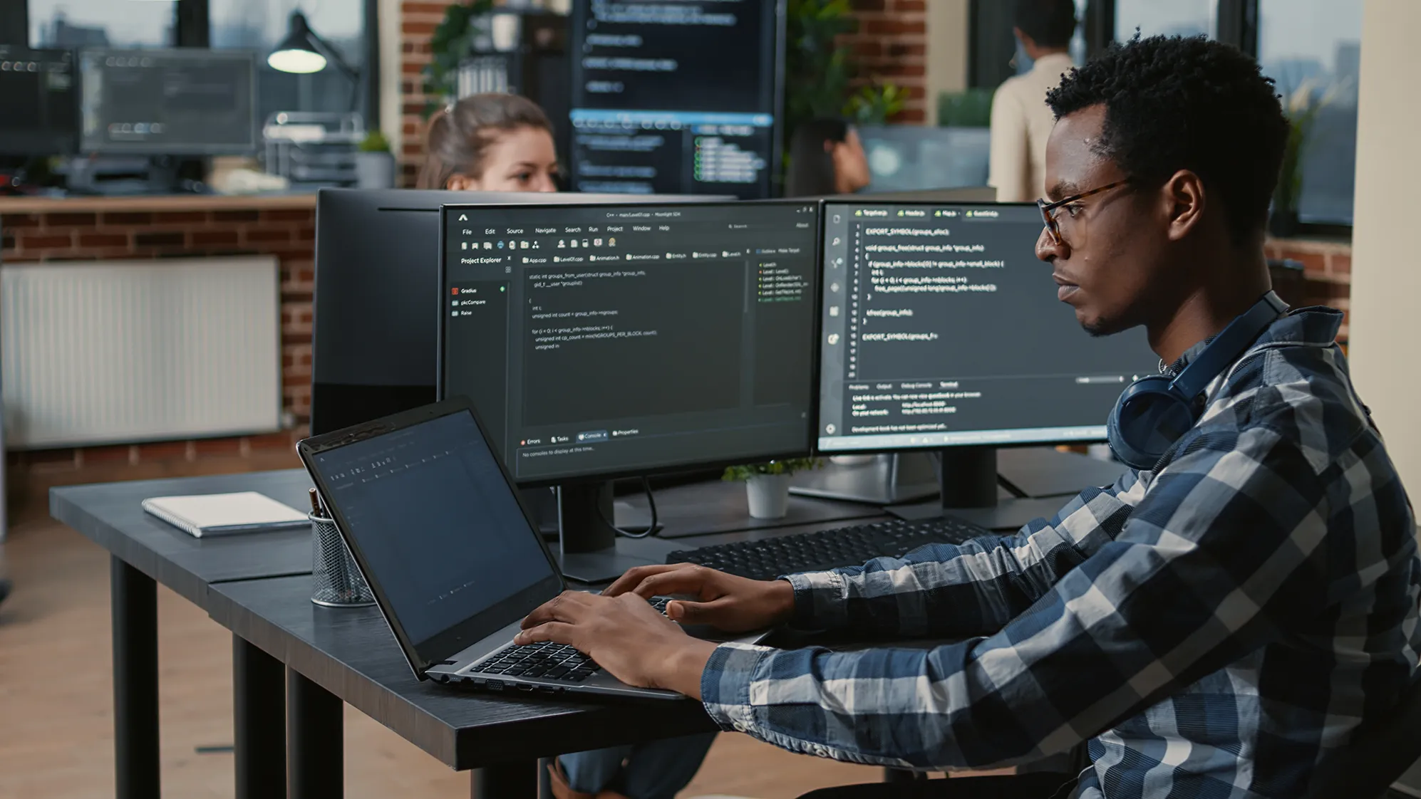 A cybersecurity expert works on coding at a computer