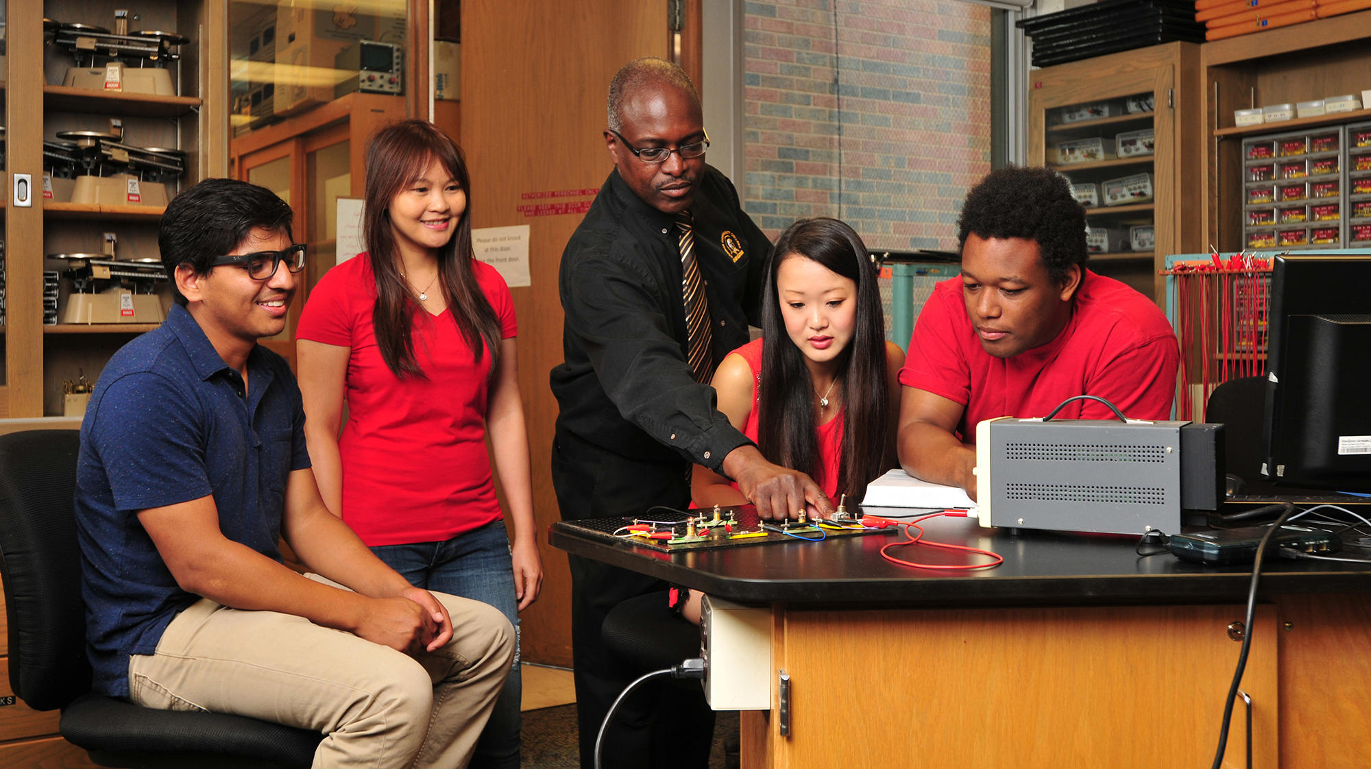 Engineering science students work at a lab table
