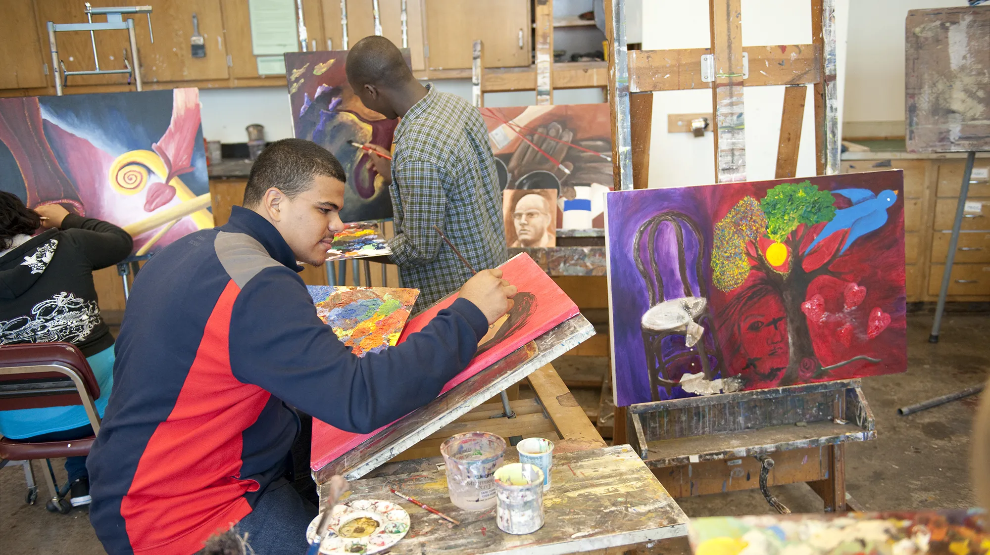 students painting in an art studio