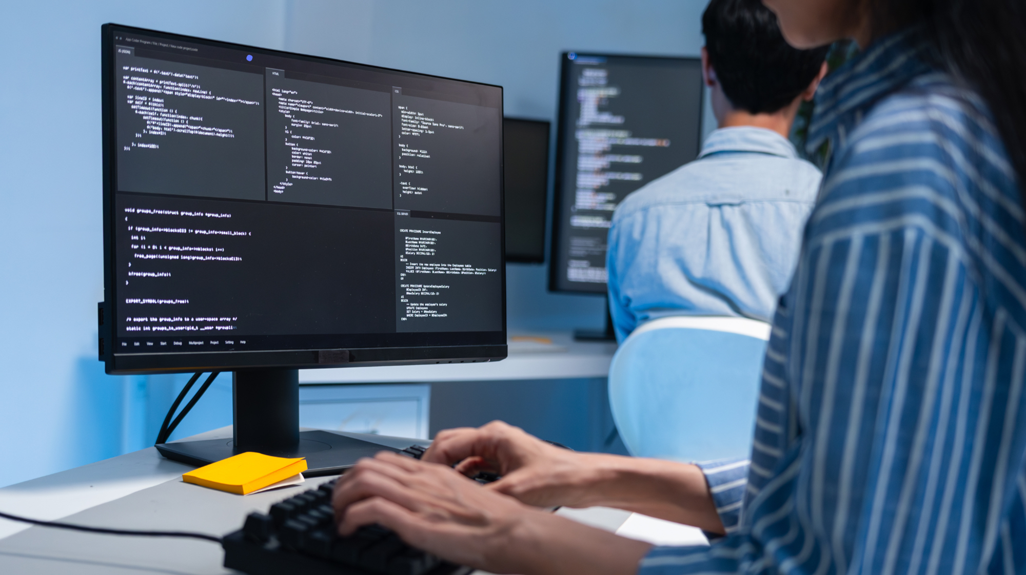 a person coding on a computer