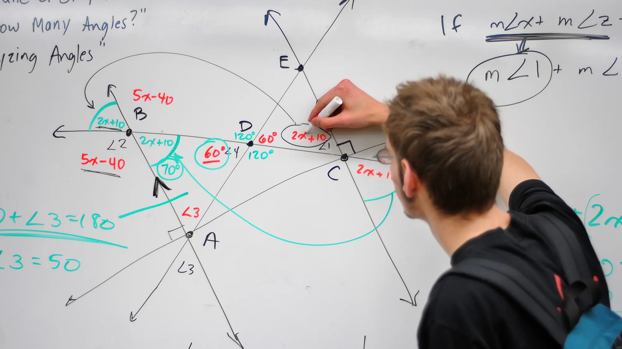 a person solving a mathematical equation on a whiteboard