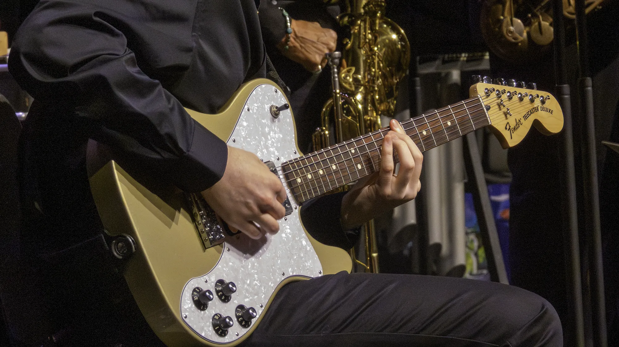 a person playing a guitar during a concert