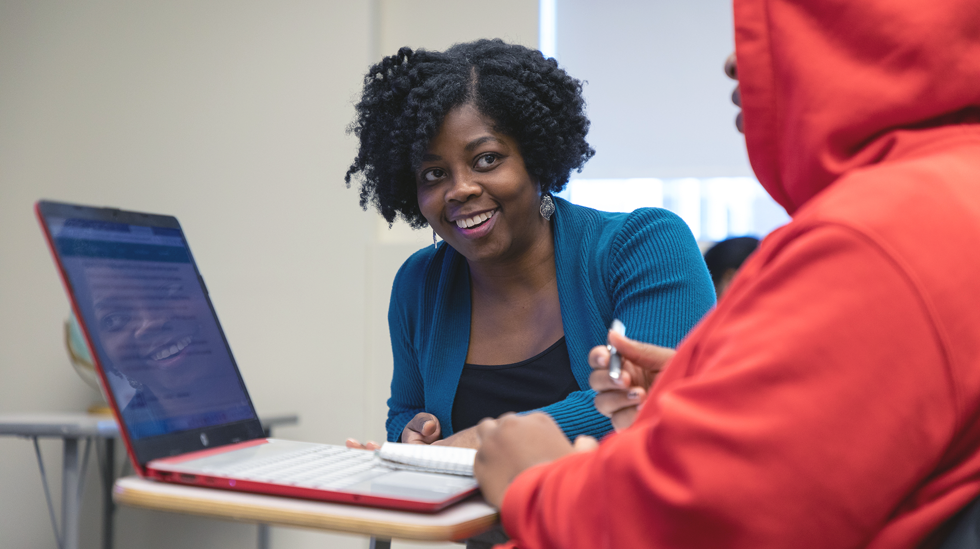 a professor helping a student in class