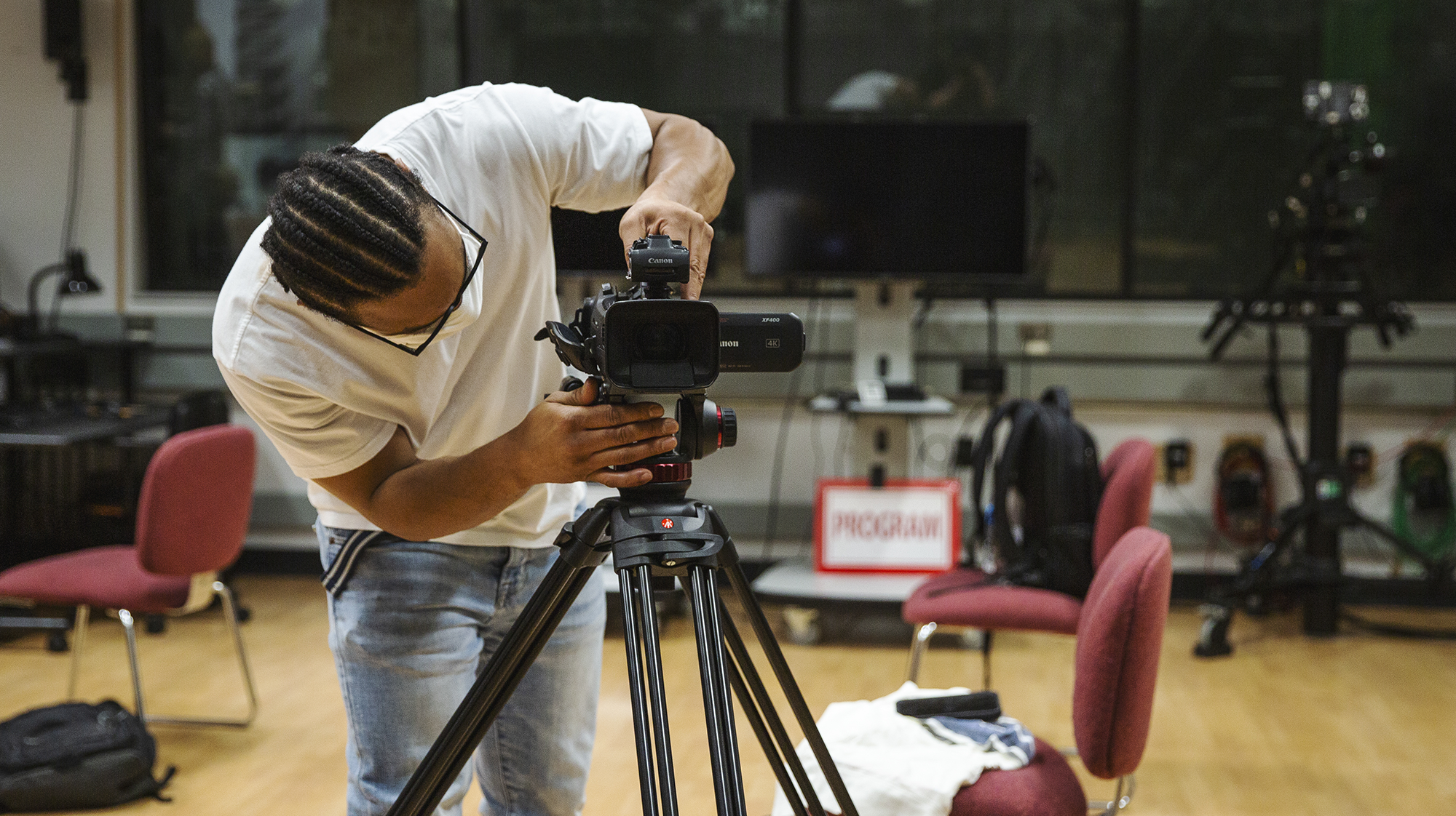 a person adjusting a video camera