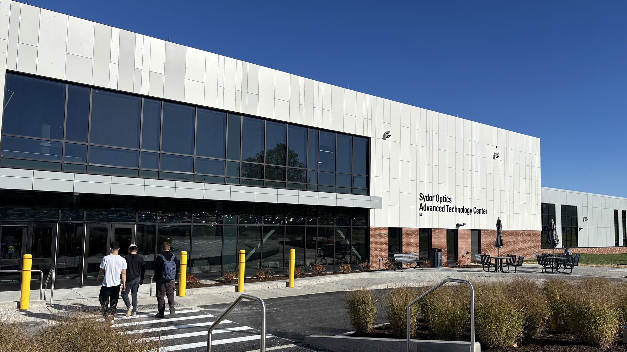 3 students walking into the Advanced Technologies Center Building