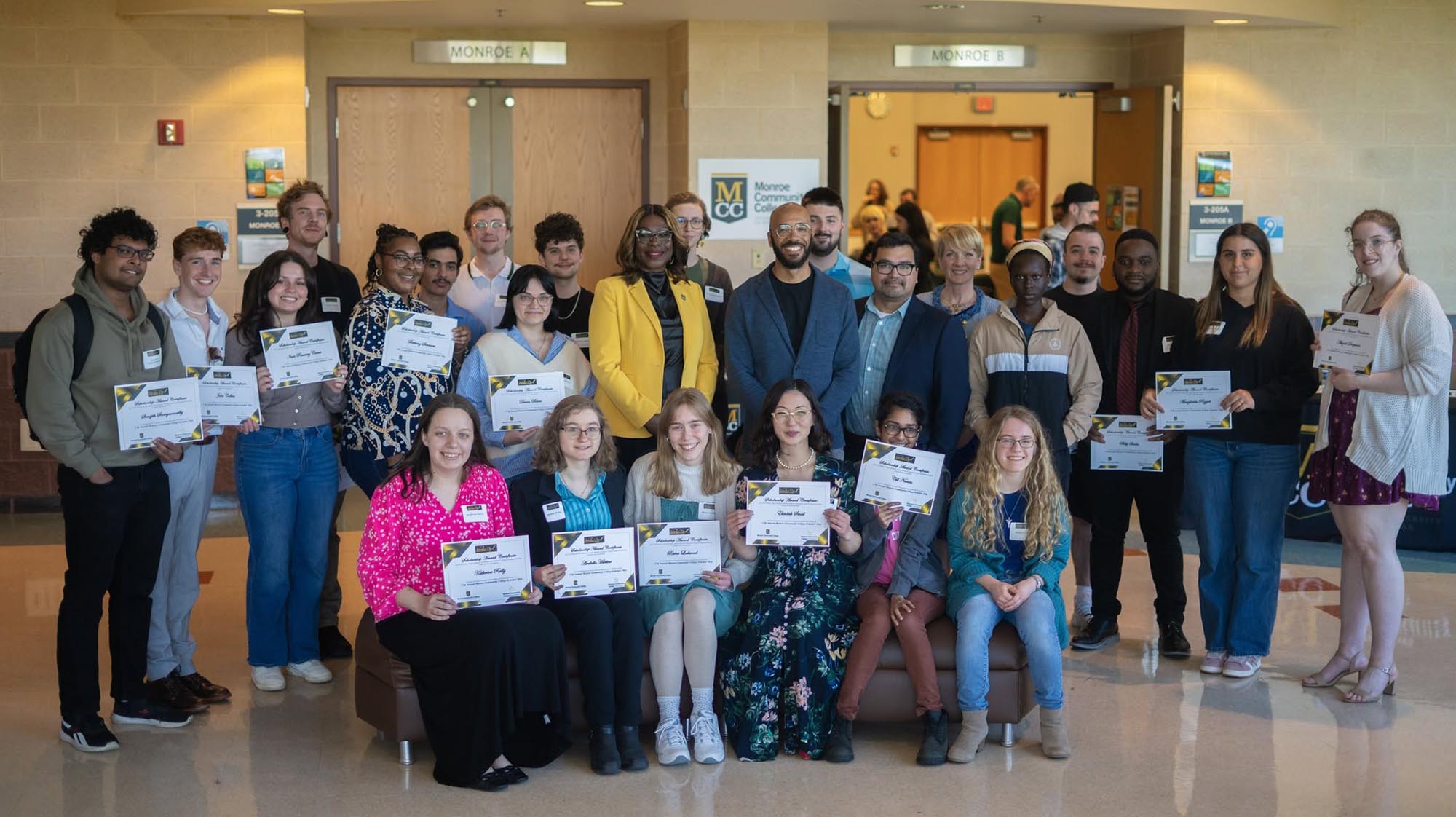 a group of students posting with scholarship papers