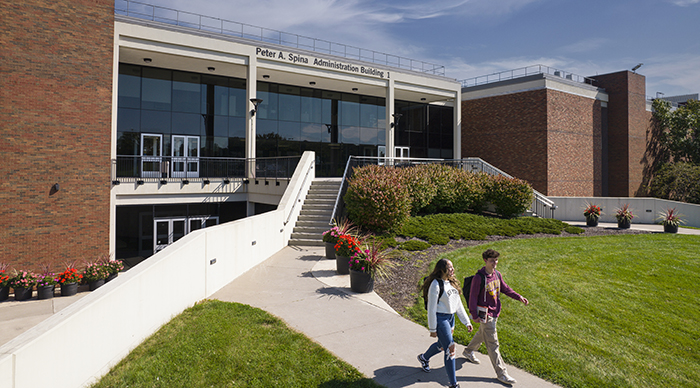 Students walking at the front entrance of the MCC Brighton campus