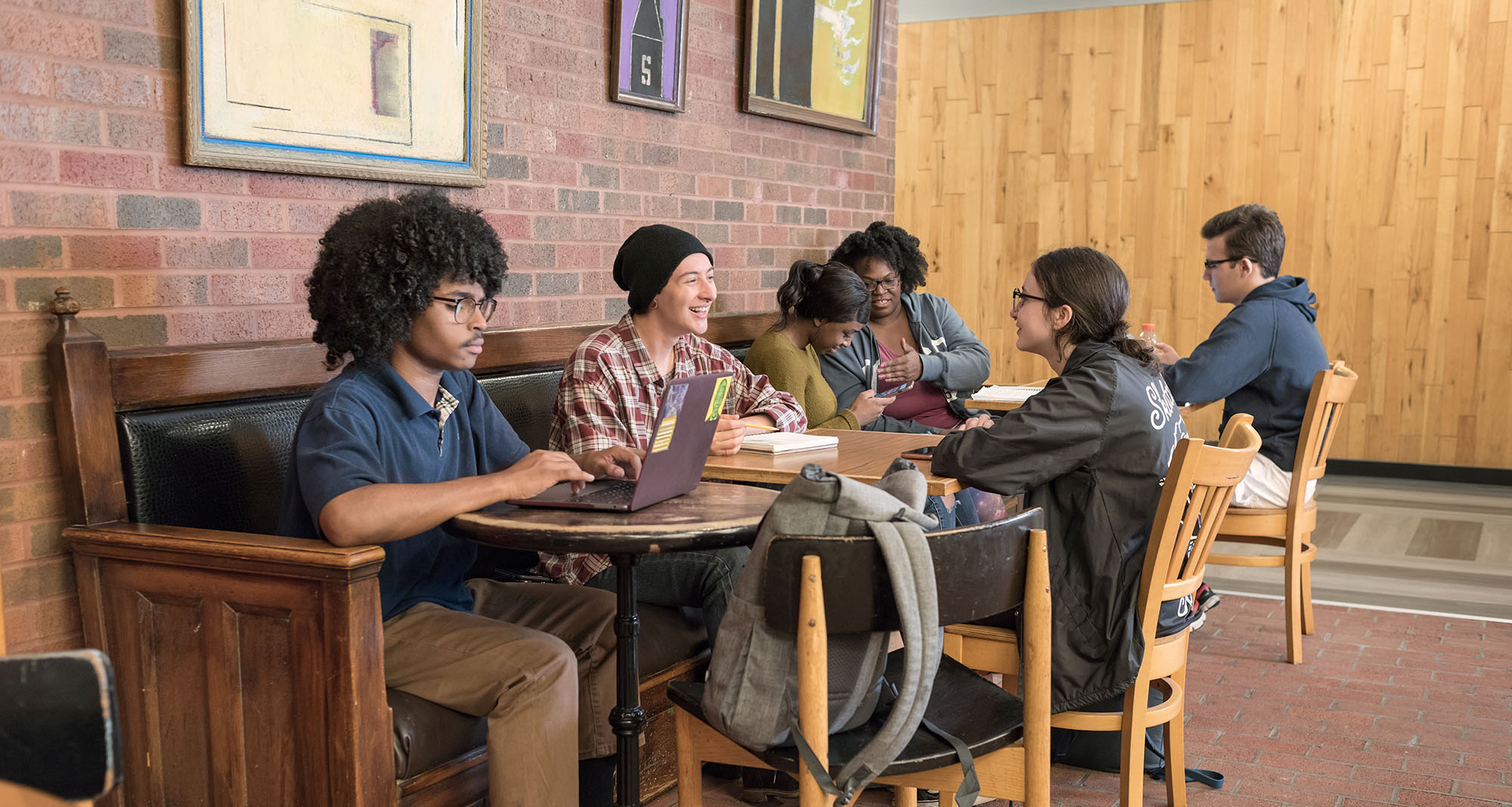 Grpoup of students studying and socializing in the college coffee shop
