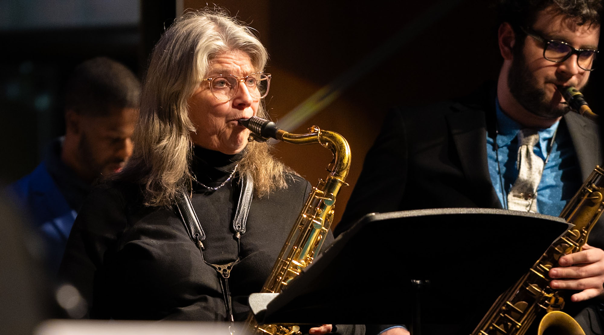 two musicians playing saxophones
