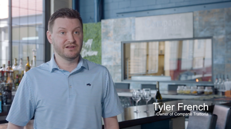 a person in a blue polo speaking to a camera, "tyler french owner of compane trattoria" text is in the bottom right corner