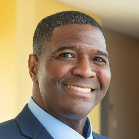 Head shot of Robin Cole smiling wearing a suit with tie.