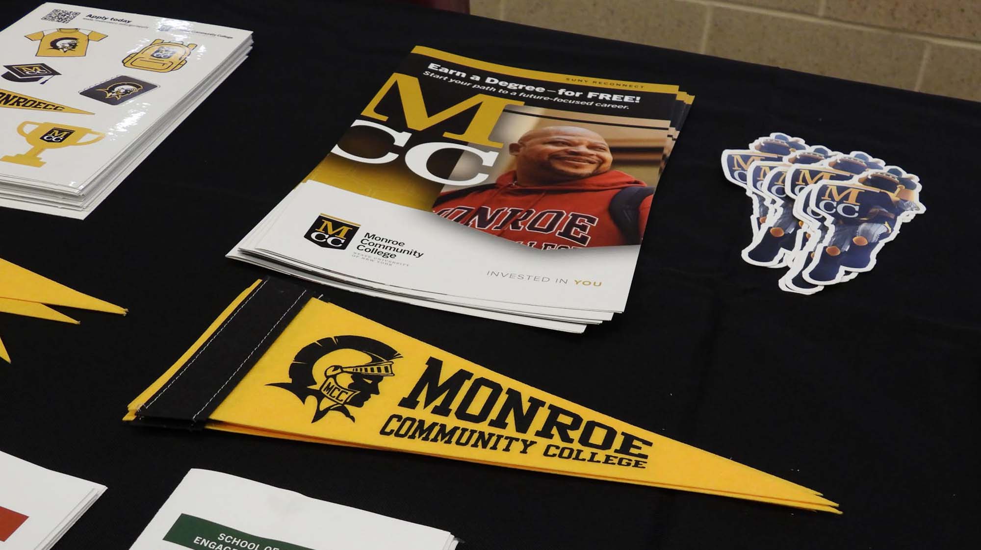 Table of MCC themed stickers and pamphlets