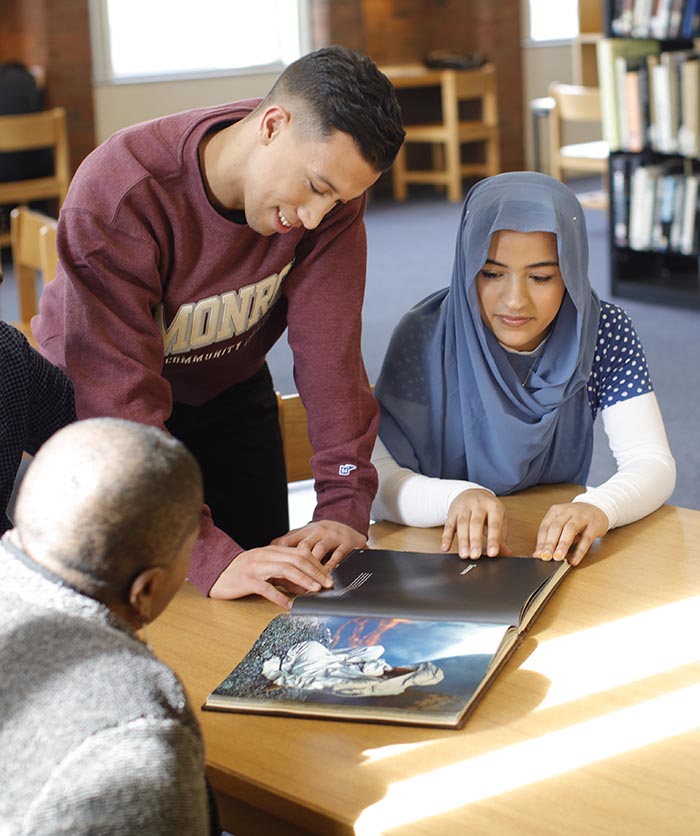 students reading a book in the library
