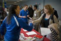 Business recruiter shakes hands with job applicant at MCC job fair.