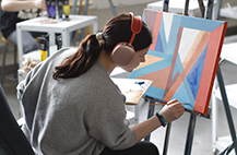 MCC art student working on painting in College studio