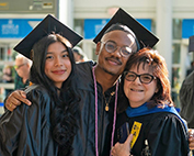 Two MCC graduates posing with Jodi Oriel, Director, Student Life and Leadership Development