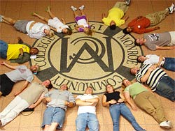 students circling the MCC seal