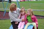 Children sitting on barrel