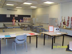 Natural Science Education Center classroom with tables, chairs, and human anatomy figure and illustrations