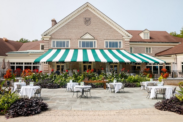 Elegant patio seating surrounded by vibrant summer plantings at the Country Club of Rochester
