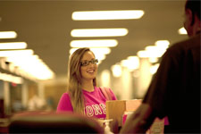 Photo of a support desk person helping a student