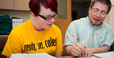 Photo of teacher helping a student