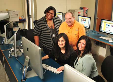 Picture of four students in computer lab