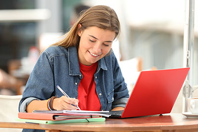 Student studying online with computer at a desk