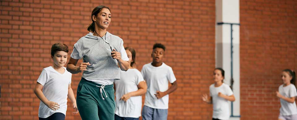 School coach jogging with students