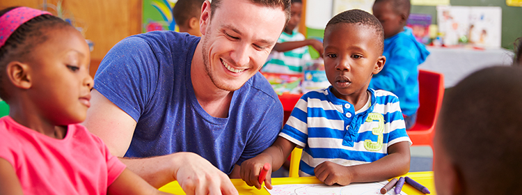 Teacher working with young kids
