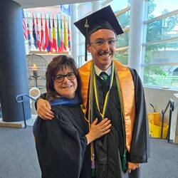 Angelo Romero, Jr., '25 with Jodi Oriel '93 in regalia