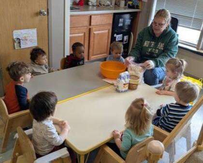 Children learning from a teacher with food