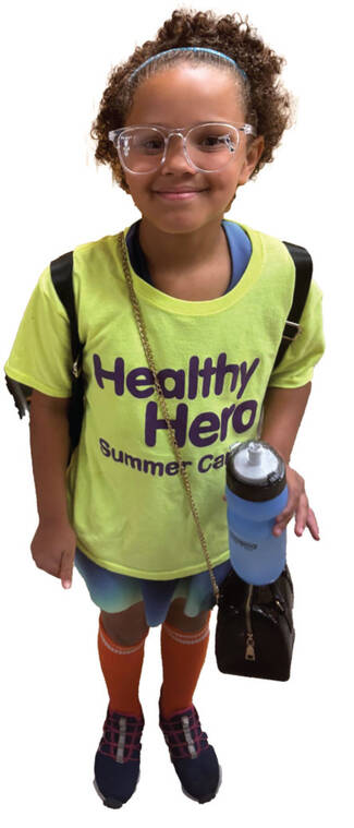 Girl with backpack in a Healthy Hereos t-shirt
