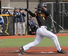 Baseball player hitting ball