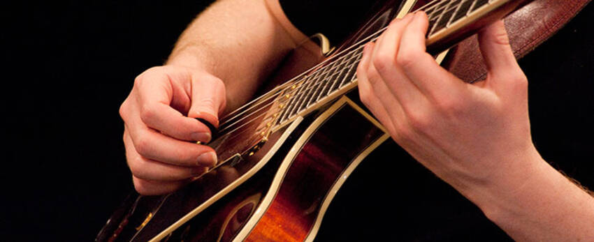 Photo of student playing guitar