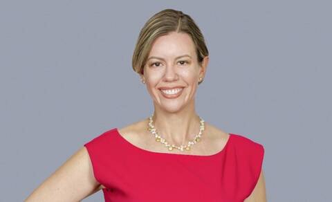 Portrait of Dr. Katie Rose Guest Pryal wearing a necklace and pink top.
