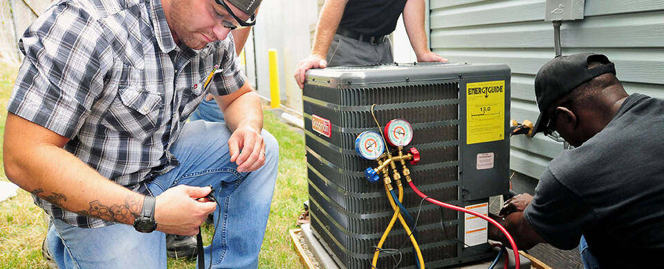 HVAC students installing an Air Conditioning unit